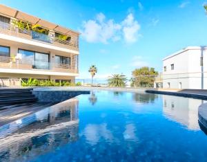 a swimming pool in front of a building at Auralys Seaside Studio avec balcon in Casablanca