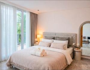 a bedroom with a bed with a teddy bear on it at Auralys Seaside Studio avec balcon in Casablanca