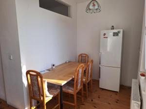 a kitchen with a wooden table and a refrigerator at Helles geteiltes Mehrbettzimmer in Leipzig