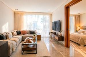 a living room with a couch and a bed at Auralys Seaside Studio avec balcon in Casablanca