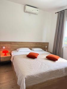 a bedroom with a large bed with two red pillows at Balcony in Shatin +39 photos