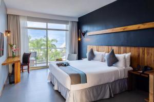 a bedroom with a large bed and a large window at Giraffe Beach Hotel in Dar es Salaam +87 photos