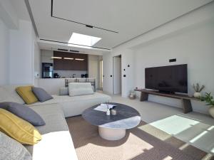 a living room with a couch and a tv at Eos Villa in Drios