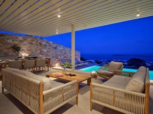 a villa with a view of the ocean at night at Eos Villa in Drios
