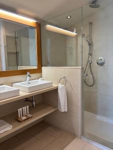 a bathroom with a sink and a shower at Hotel Llafranch in Llafranc +54 photos