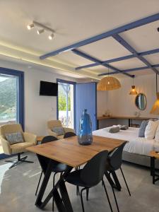 a bedroom with a table and chairs and a bed at THALASSA in Livadia