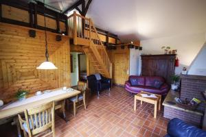 a living room with a spiral staircase in a house at Ferienhaus Alicia in Hilders