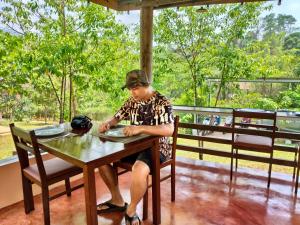 a man sitting at a table with a plate at GJ TOUR and HOMESTAY in Pang Mapha +140 photos