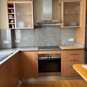 a kitchen with wooden cabinets and a stove top oven at Kalma Samaria in Pals