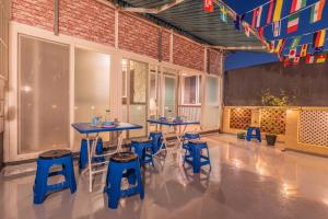 a room with two tables and blue stools at 행궁주택 in Samgong