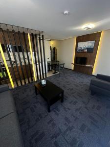 a living room with a couch and a table at Loft Tepe Hotel in Dikmen