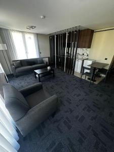 a living room with a couch and a table at Loft Tepe Hotel in Dikmen +26 photos