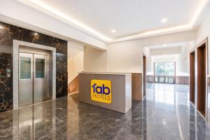 a lobby of a hotel with a sign on the wall at FabHotel Destiny Living in Pune
