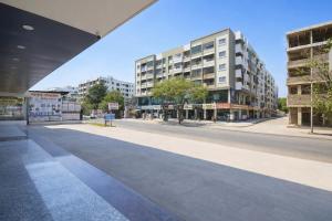 an empty street in a city with tall buildings at FabHotel Destiny Living in Pune