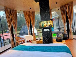 a bedroom with a bed and a flat screen tv at Airas Resort in Kūkkāl
