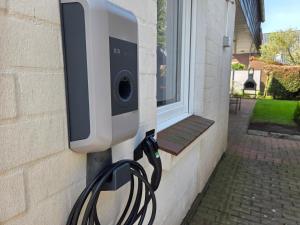 a security camera on the side of a building at Nr 64 - Ferienhaus Krabbe 12 in Carolinensiel