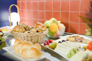 a buffet of food with bread and fruit on a table at Hotel Profis in Diepoldsau
