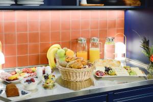 a buffet of breakfast foods and drinks on a counter at Hotel Profis in Diepoldsau