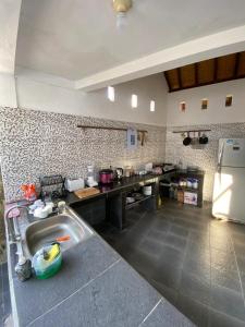 a kitchen with a sink and a refrigerator at Inti Bungalows in Gili Trawangan