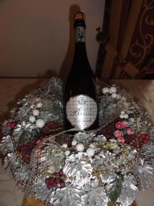 a bottle of wine on a table with christmas decorations at Casa Do Brasao in Tabuaço