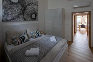 a bedroom with a bed and a dining room at Apartmány LISON in Valtice