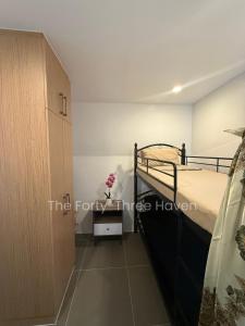 a bedroom with a bunk bed and a cabinet at The Forty-Three Haven in Calo