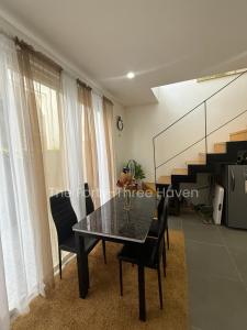 a dining room with a black table and chairs at The Forty-Three Haven in Calo +3 photos