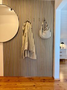 a room with a black and white striped wall at Landhaus Wulfenia - APARTMENT KLAGENFURT - Private Sauna, Smart-TV, Air Conditioning, Free Parking in Klagenfurt