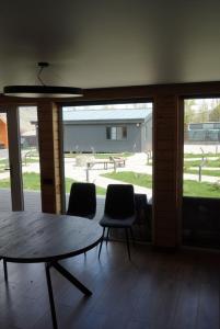 a room with a table and chairs and a patio at Turanga hotel in Saty