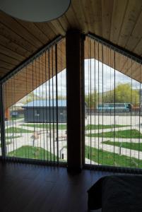 a room with large windows with a view of a park at Turanga hotel in Saty