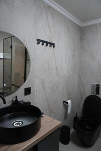 a bathroom with a black sink and a mirror at Turanga hotel in Saty +12 photos