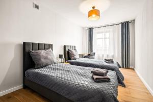 a bedroom with two beds with towels on them at Platinum Elite Residence in Rybnik