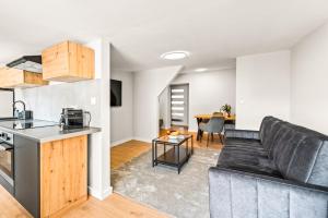 a kitchen and living room with a couch and a table at Platinum Elite Residence in Rybnik +12 photos