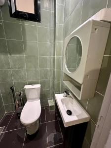 a bathroom with a toilet and a sink and a mirror at Urban Loft Dakar by Immo Kit BNB in Dakar +32 photos