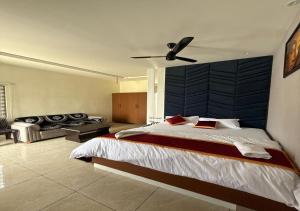 a bedroom with a large bed with a blue wall at SNR GRAND in Narasaraopet