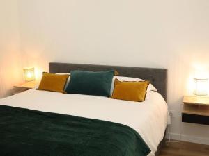 a bedroom with a large bed with two lamps at Suite des Princes with Private Garden by La Boîte En Plus in Chantilly