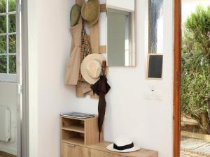 a door with a hat and an umbrella on a wall at Suite des Princes with Private Garden by La Boîte En Plus in Chantilly +3 photos