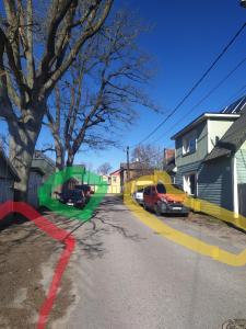 a street with cars parked on the side of the road at Tempel Apartement in Pärnu
