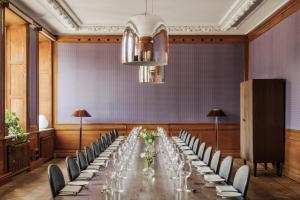 a conference room with a long table and chairs at Nobis Hotel Stockholm, a Member of Design Hotels in Stockholm