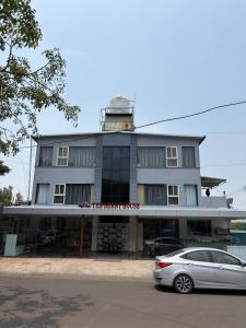 a car parked in front of a building with a lighthouse at The Berry House in Satara