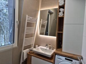 a bathroom with a sink and a mirror at Oaza in Bjelašnica +56 photos