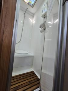 a small bathroom with a shower and a toilet at A Tiny Home Experience in a great spot in Melbourne