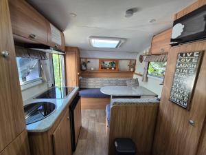 an rv kitchen with a sink and a counter top at A Tiny Home Experience in a great spot in Melbourne +4 photos