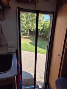 an open door of a rv with a yard at A Tiny Home Experience in a great spot in Melbourne