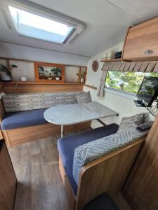 a view of the inside of a rv with a table at A Tiny Home Experience in a great spot in Melbourne