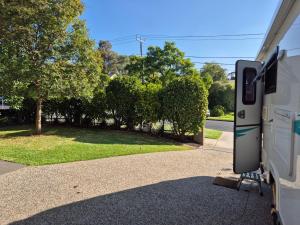 a white truck parked on the side of a road at A Tiny Home Experience in a great spot in Melbourne