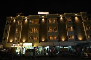 a large building with a sign on it at night at Hotel Sree Kanya Inn in Visakhapatnam