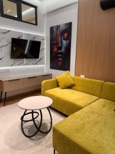 a living room with a yellow couch and a table at Apartment prime residence in Ak-Tyube