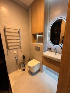 a bathroom with a toilet and a sink at Apartment prime residence in Ak-Tyube +11 photos