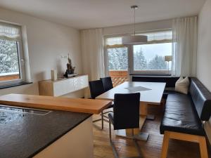a kitchen and living room with a table and a couch at Alpenapartments Unterschlag in Annaberg im Lammertal
